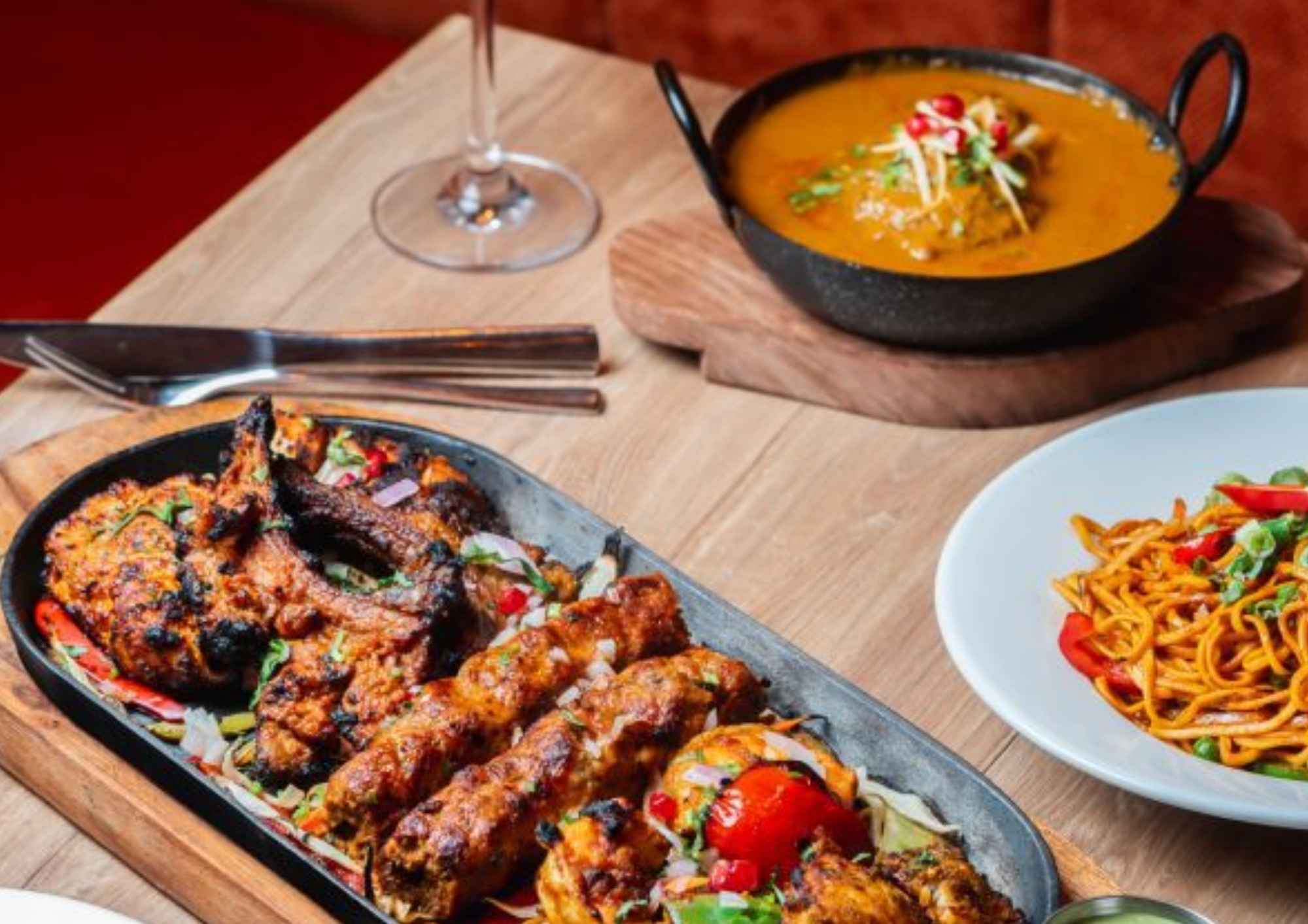 Assorted Indian and Nepalese grilled dishes served with sides and sauces.