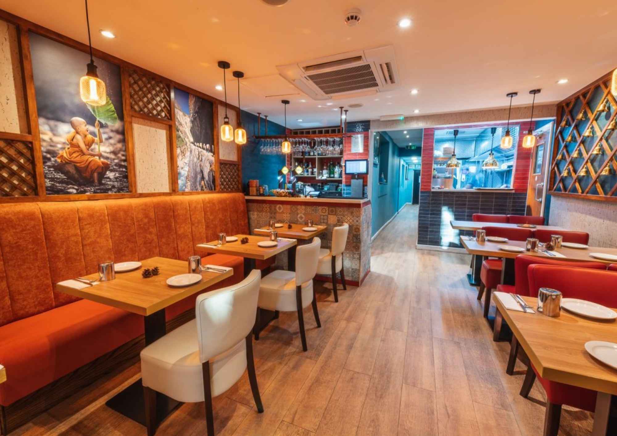 Modern restaurant interior with seating arrangement and warm ambient lighting.